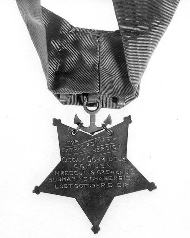 The back of a star-shaped medal shows an inscription.