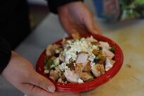 Staff Sgt. Katie Mazos-Vega, a public affairs specialist with the 134th Public Affairs Detachment, shows her completed protein bowl as part of a nutrition class taught by Sgt. 1st Class Melissa Ferguson, an officer candidate school instructor with 207th Multi-Functional Training Regt. during the annual wellness camp held at Camp Carroll, Joint Base Elmendorf-Richardson, Alaska, Aug. 30, 2022. The annual wellness camp focuses on the Army’s Holistic Health and Fitness concept and prepares Soldiers to maintain an overall healthy lifestyle. (Alaska National Guard photo by Sgt. Kekoa Macloves)
