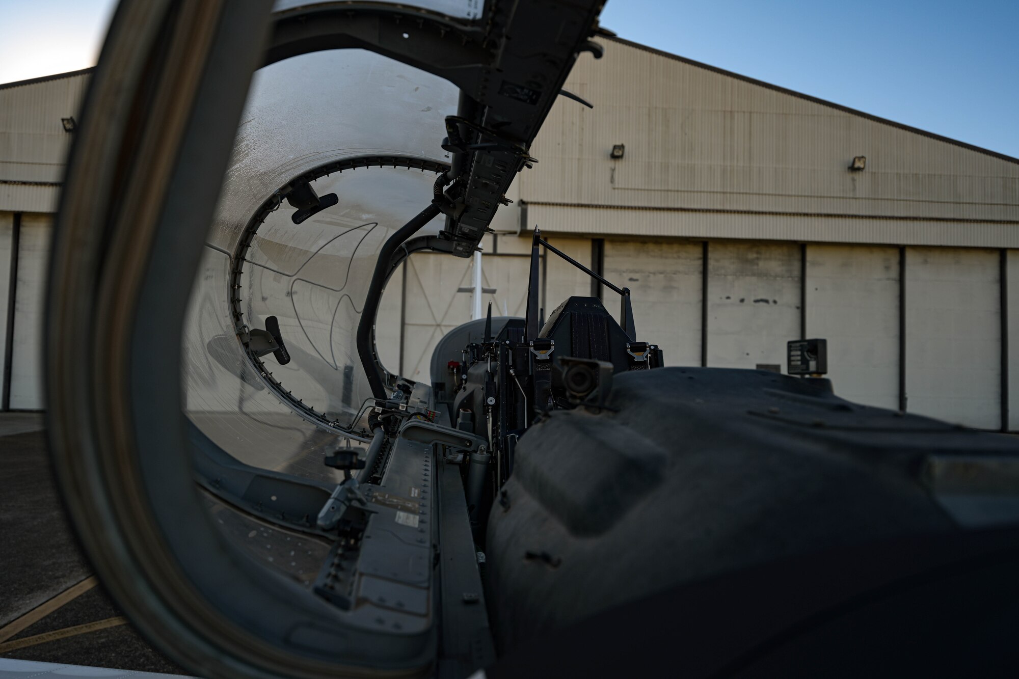 An open canopy of a T-6A Texan II aircraft displayed in the maintenance quadrant, September 30, 2022, on Columbus Air Force Base, Miss. Pilots enter the T-6 cockpit through a side-opening, one-piece canopy that has demonstrated resistance to bird strikes at speeds up to 270 knots. (U.S. Air Force photo by Staff Sgt. Jake Jacobsen)
