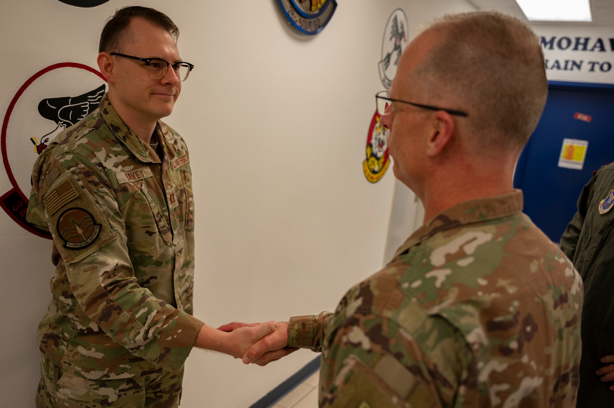 Lt. Gen. Mark Weatherington, Air Force Global Strike Command deputy commander, right, coins Capt. Tristan Davey, 7th Operations Support Squadron weather flight commander, at Dyess Air Force Base, Texas, Sept. 23, 2022. Davey was coined for leading the redesign of the inter-continental U.S. and bomber task force weather product, consolidating the existing 15 brief templates to two slides. This standardized the product, improving speed of creation, readability and fidelity. (U.S. Air force photo by Senior Airman Reilly McGuire)