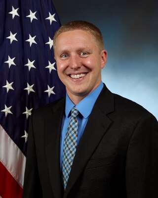 Portrait of man with flag in background