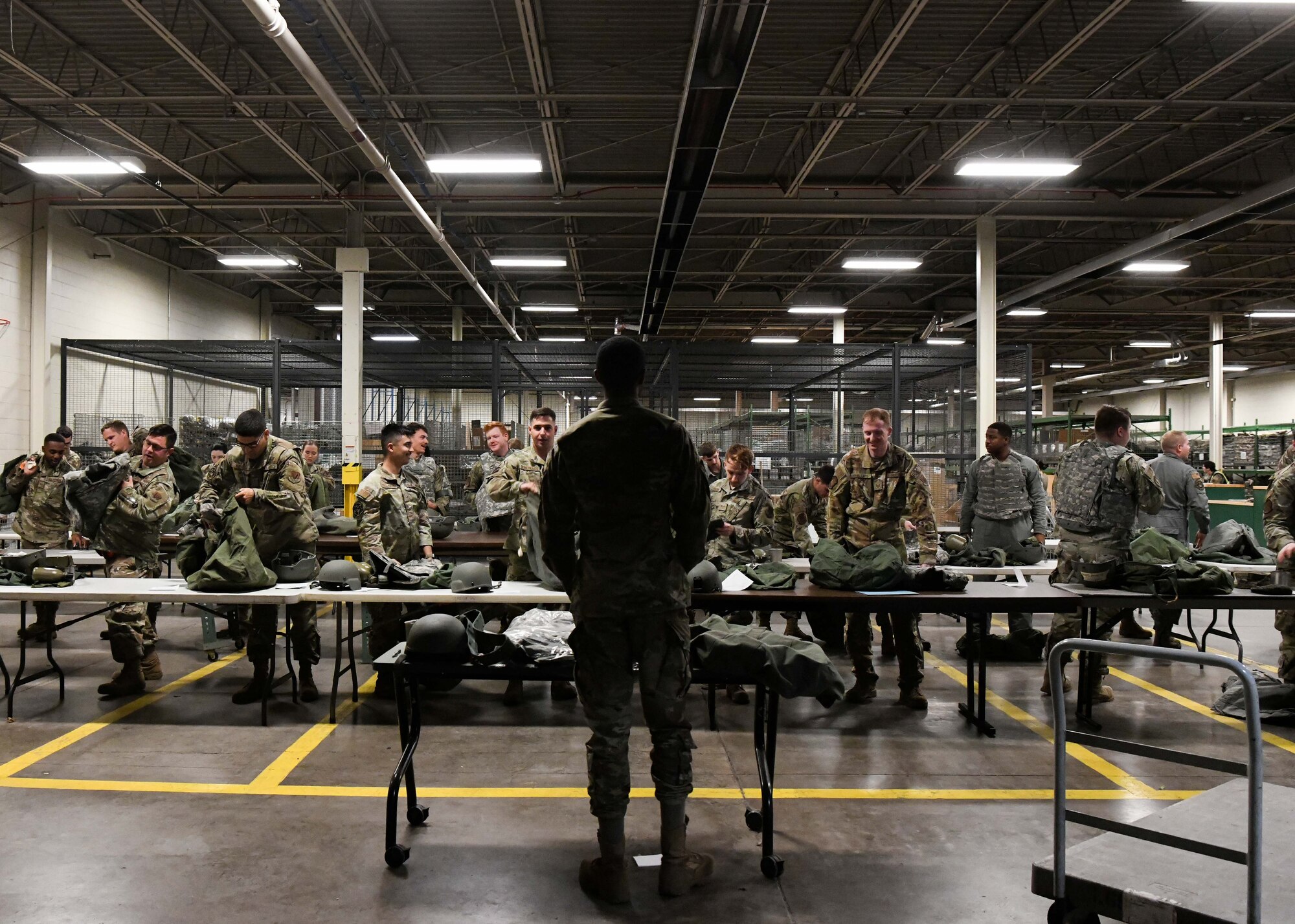 U.S. Air Force Senior Airman Byron Williams, 319th Logistic Readiness Squadron individual protective equipment journeyman, briefs exercise participants on proper gear wear Sept. 26, 2022, during Readiness Exercise Validation Global Griffin 09-22 on Grand Forks Air Force Base, North Dakota. Each participant was issued an A-Bag that included a helmet, vest, web-belt and canteen. (U.S. Air Force photo by Senior Airman Ashley Richards)