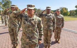 Soldiers salute during the National Anthem