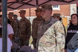 Soldiers and family members attend a deployment ceremony