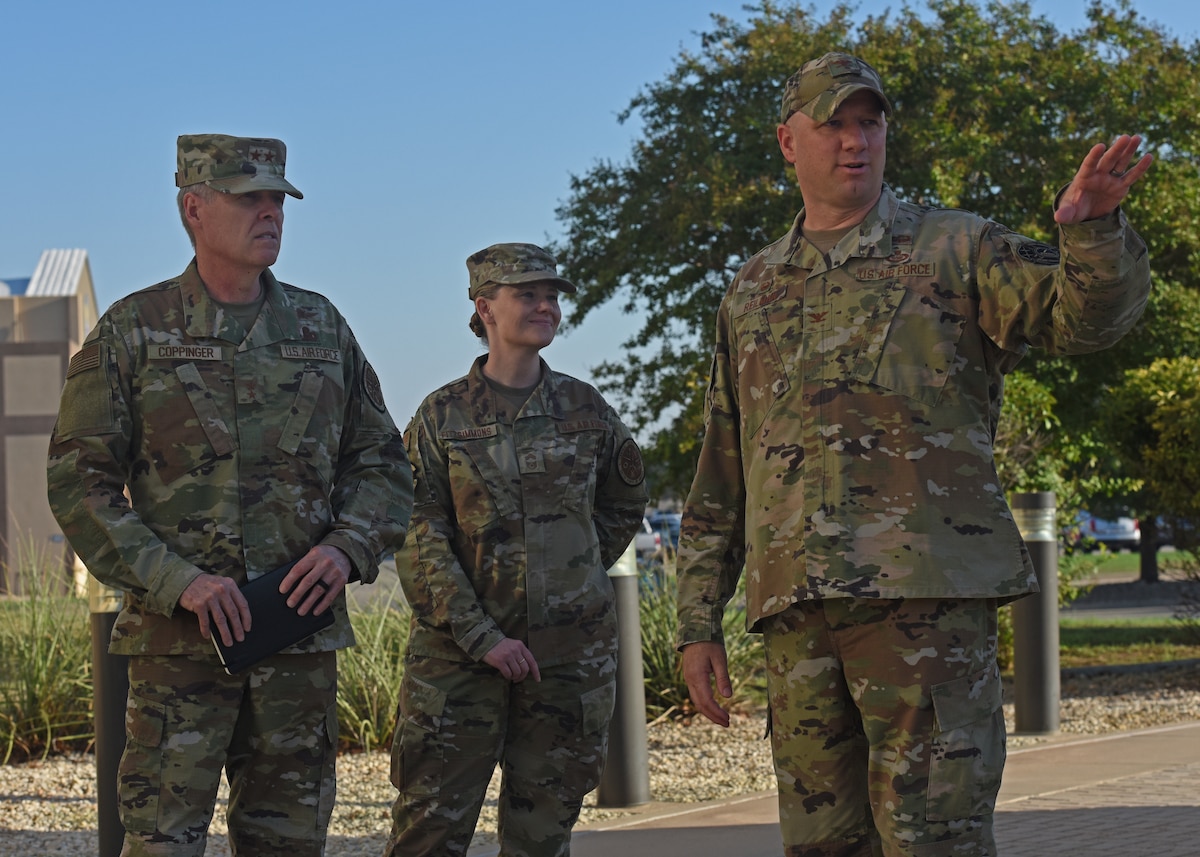 U.S. Air Force Col. Matthew Reilman, 17th Training Wing commander, shows Maj. Gen. Douglas Coppinger, Central Security Service deputy chief, a static display outside the 17th TRW Headquarters at Goodfellow Air Force Base, Texas, September 9, 2022. The 17th TRW trains, transforms, and empowers joint and coalition warriors. (U.S. Air Force photo by Airman 1st Class Zachary Heimbuch)