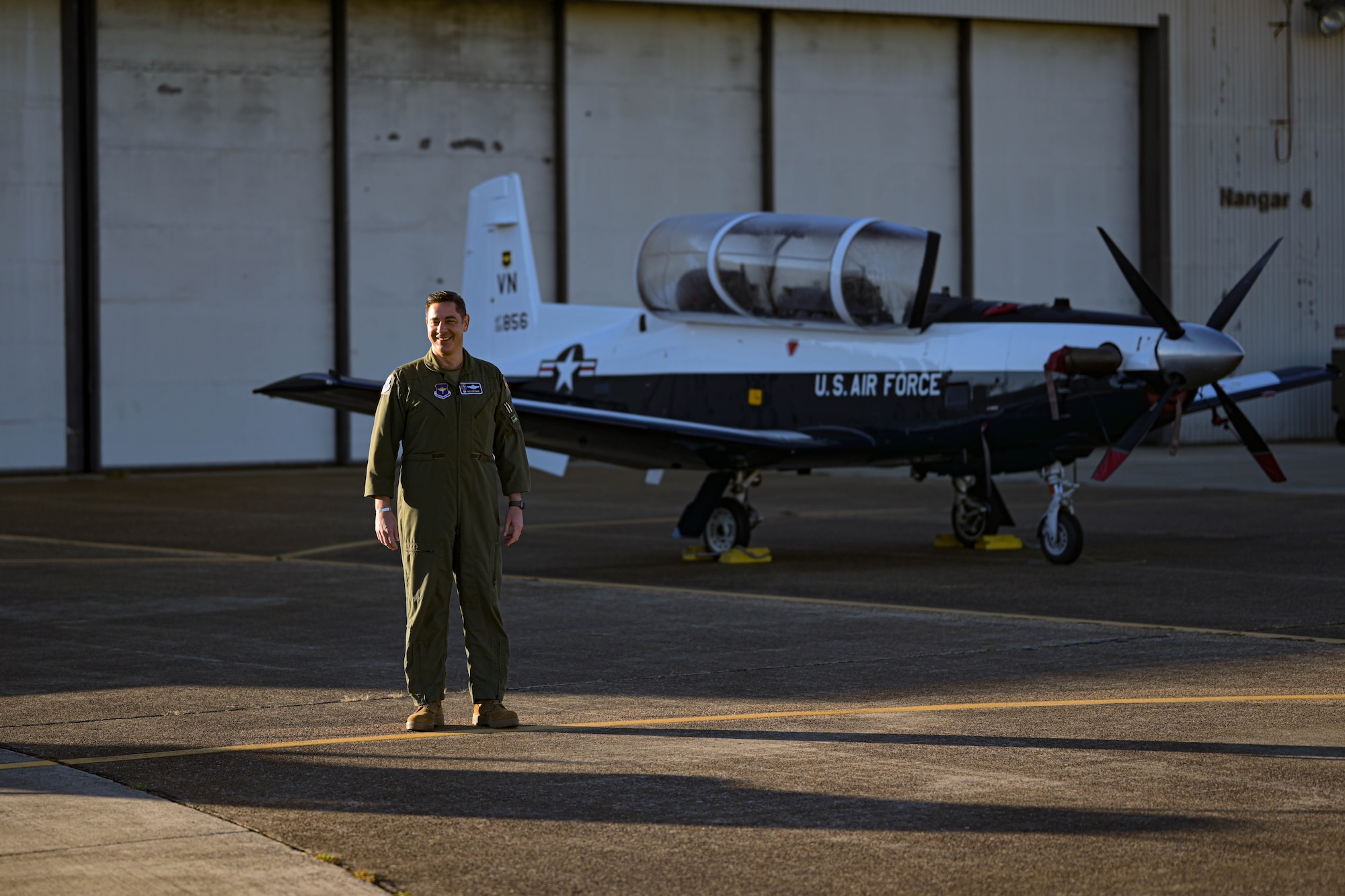 U.S. Air Force Col. Alexander Heyman, 14th Flying Training Wing Operations Group commander, stands in front of a T-6A Texan II visiting from Vance Air Force Base in the maintenance quadrant, September 30, 2022, on Columbus AFB, Miss. The T-6, tail number 856, was visiting Columbus AFB for a new paint job before returning to Vance. (U.S. Air Force photo by Staff Sgt. Jake Jacobsen)