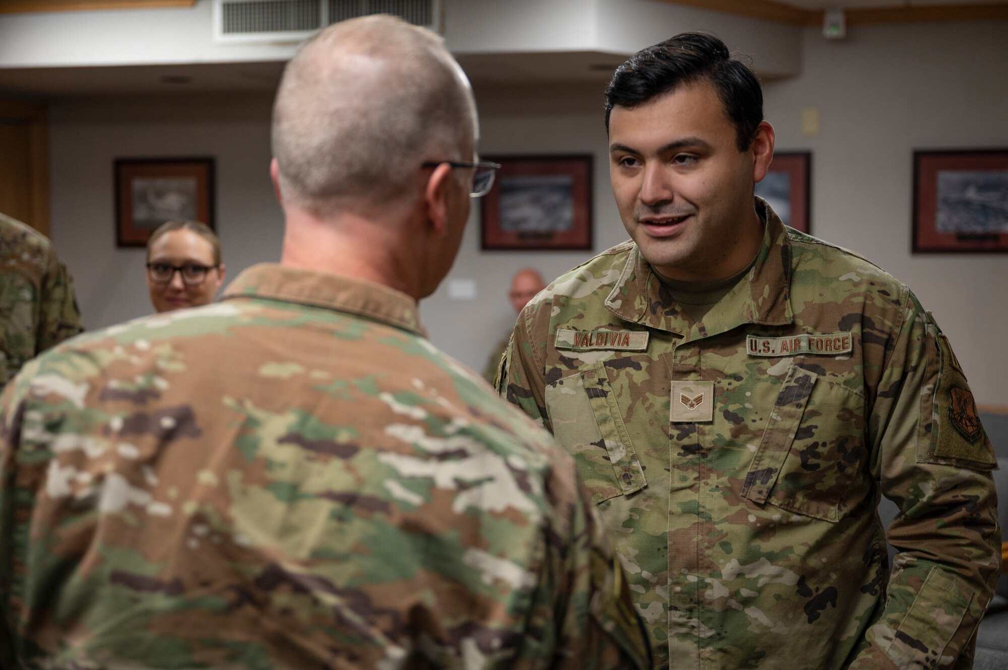 Lt. Gen. Mark Weatherington, Air Force Global Strike Command deputy commander, left, coins Senior Airman Lawrence Valdivia, 7th Comptroller Squadron financial analysis technician, at Dyess Air Force Base, Texas, Sept. 23, 2022. Valdivia was recognized for consistently and persistently stepping up to lead within the 7th CPTS. (U.S. Air force photo by Senior Airman Reilly McGuire)