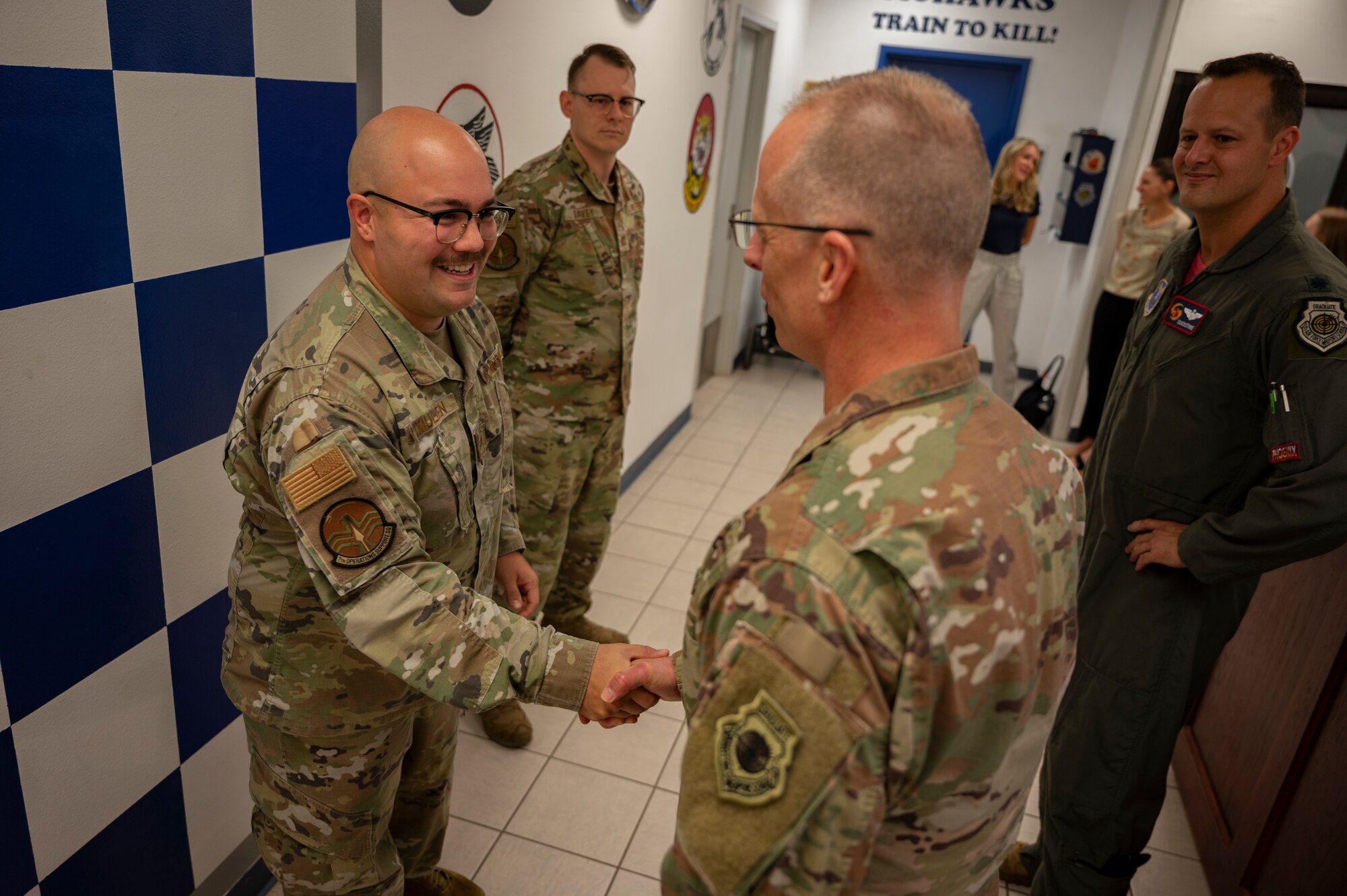 Lt. Gen. Mark Weatherington, Air Force Global Strike Command deputy commander, right, coins Staff Sgt. Dylan Mullen, 7th Operations Support Squadron airfield management operations supervisor, at Dyess Air Force Base, Texas, Sept. 23, 2022. Mullen was recognized for calling across five different Spanish speaking nations to coordinate flight operations during a higher headquarters mission in South America, , mitigating air space deviations and delays. (U.S. Air force photo by Senior Airman Reilly McGuire)