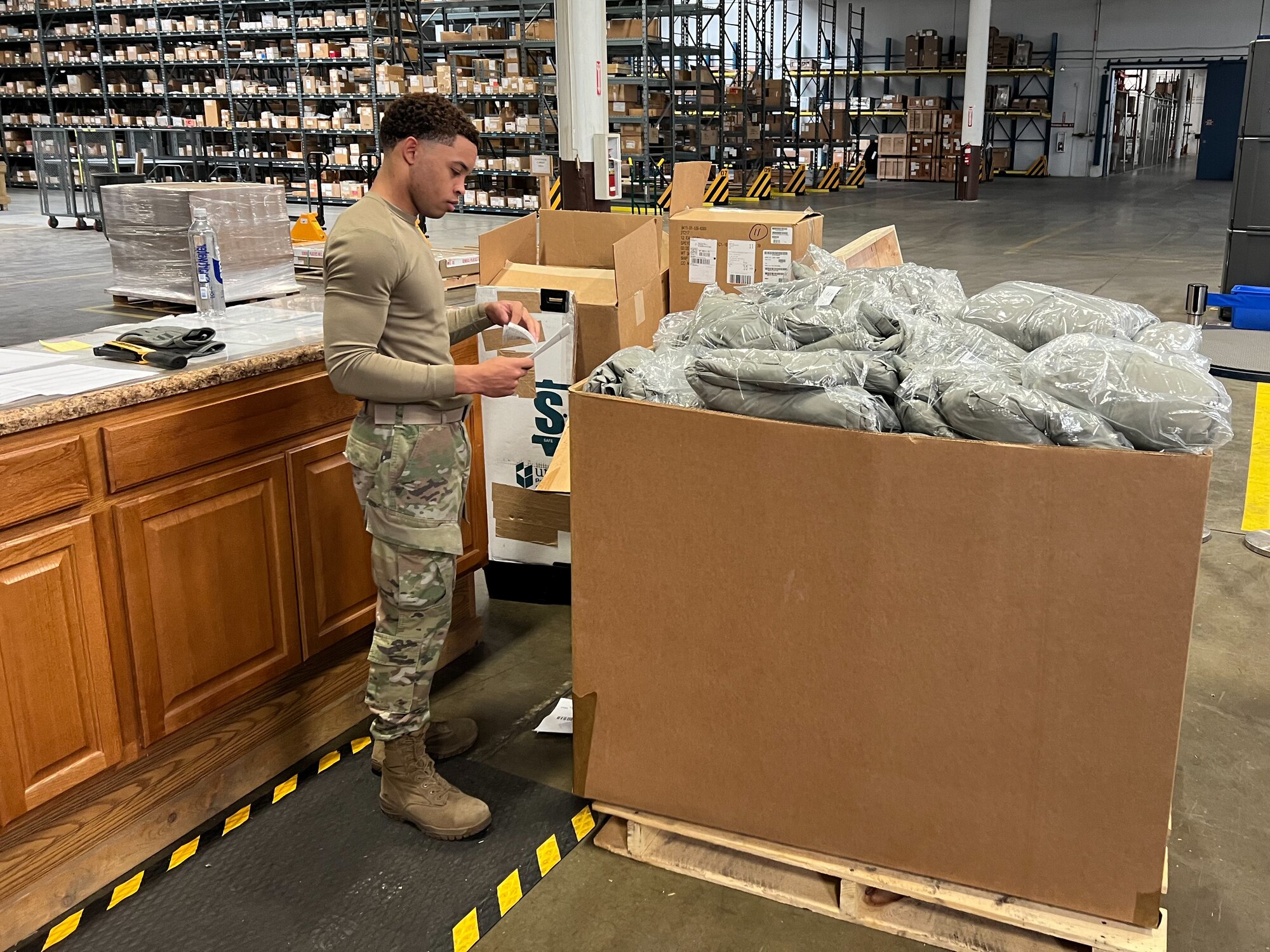Staff Sgt. Kentrell Dragg, 90th Logistics Readiness Squadron NCOIC of packing and crating, finishes the necessary shipping labels and forms on F.E. Warren Air Force Base, Wyoming, Sept. 29, 2022. As part of a Department of Defense effort to provide foreign aid, the 90 LRS mobility flight packed and shipped 111 parkas to the front lines in Eastern Europe. (U.S. Air Force photo by Robert DuPont)