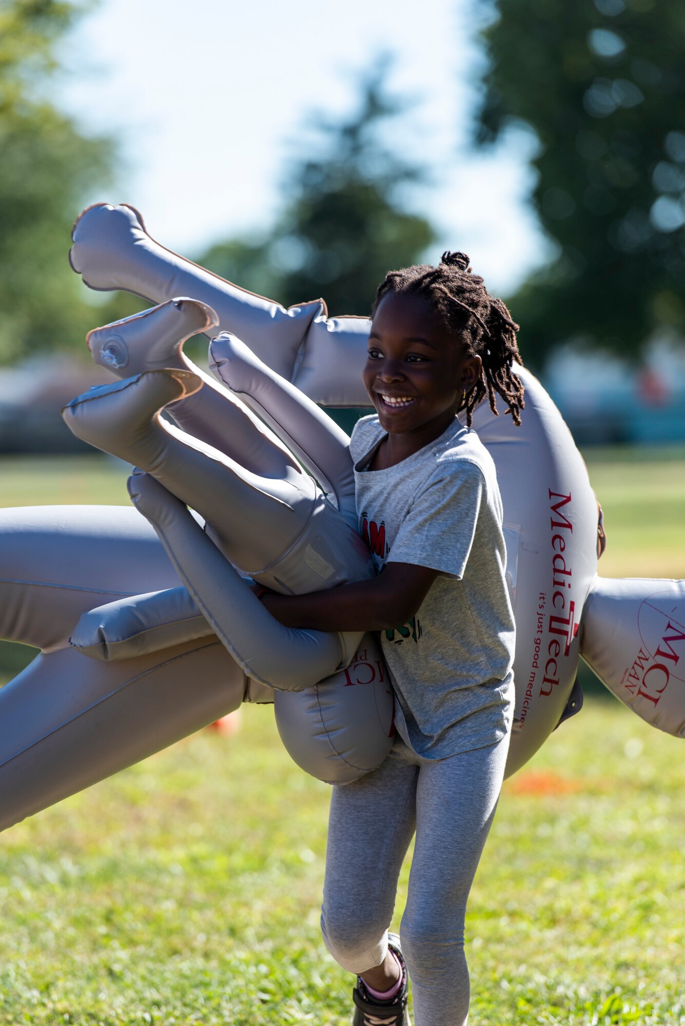 A child carries a dummy.