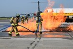 Firefighters with the 167th Civil Engineering Squadron practice their extinguishing techniques with the West Virginia University Fire Service Extension’s mobile aircraft fire simulator during an emergency response exercise at the at the 167th Airlift Wing, Shepherd Field, Martinsburg, West Virginia, Sept. 16, 2022.