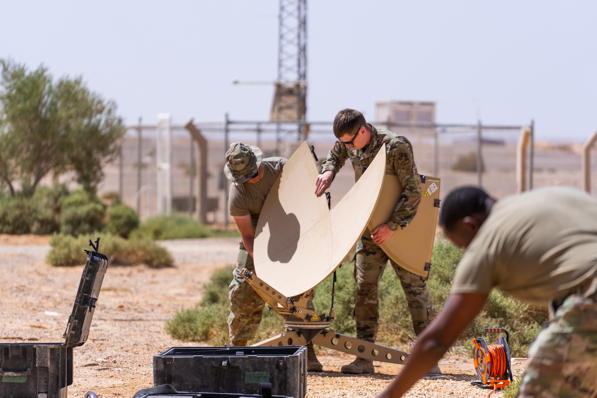 U.S. Air Force Airmen with the 332d Expeditionary Communications Squadron constructs a Communications Fly-away Kit (CFK) during a training exercise designed around Agile Combat Employment, at an undisclosed location in Southwest Asia, September 27-28, 2022. A CFK was established and provides satellite communications anywhere in the world, even in austere environments with little or no infrastructure. (U.S Air Force Photo by Tech Sgt. Melissa Isidro)