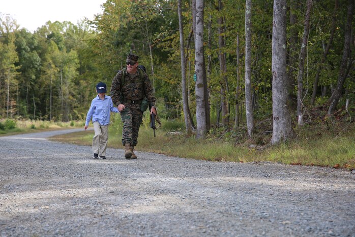 Col. Mullins was accompanied by his 8-year-old grandson, Blake, during the final mile of his 20-mile hike, representative of his expansive career in the U.S. Marine Corps. He retired from the U.S. Marine Corps after 31 years of faithful service on Sept. 29, 2022, at a ceremony at Marine Corps Base Quantico’s 395-acre Transportation Demonstration Support Area. The ceremony was officiated by Gen. Eric M. Smith, the assistant commandant of the Marine Corps, and attended by family, friends and former Marine Corps colleagues.