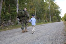 Col. Mullins was accompanied by his 8-year-old grandson, Blake, during the final mile of his 20-mile hike, representative of his expansive career in the U.S. Marine Corps. He retired from the U.S. Marine Corps after 31 years of faithful service on Sept. 29, 2022, at a ceremony at Marine Corps Base Quantico’s 395-acre Transportation Demonstration Support Area. The ceremony was officiated by Gen. Eric M. Smith, the assistant commandant of the Marine Corps, and attended by family, friends, and former Marine Corps colleagues.