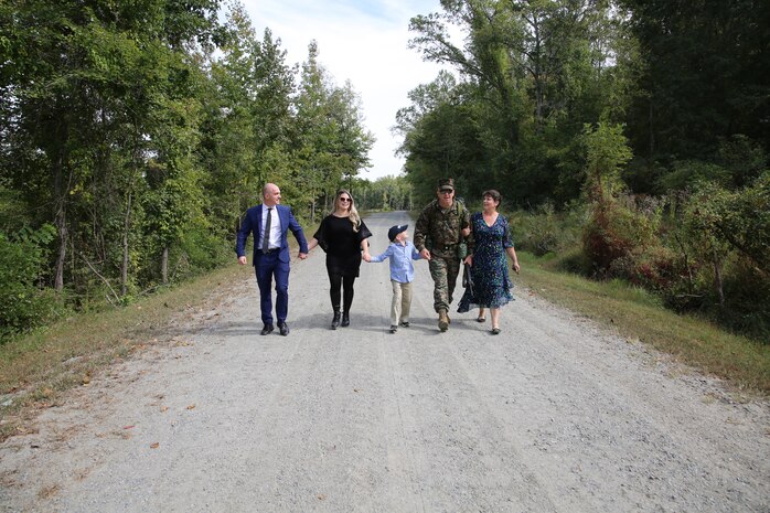 Col. Kirk D. Mullins is pictured above walking alongside his family towards his retirement ceremony at Marine Corps Base Quantico’s 395-acre Transportation Demonstration Support Area on Sept. 29, 2022. The ceremony was officiated by Gen. Eric M. Smith, the assistant commandant of the Marine Corps, and attended by family, friends, and former Marine Corps colleagues.