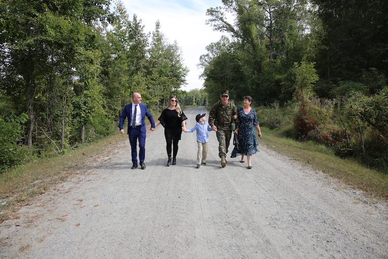 Col. Kirk D. Mullins is pictured above walking alongside his family towards his retirement ceremony at Marine Corps Base Quantico’s 395-acre Transportation Demonstration Support Area on Sept. 29, 2022. The ceremony was officiated by Gen. Eric M. Smith, the assistant commandant of the Marine Corps, and attended by family, friends, and former Marine Corps colleagues.