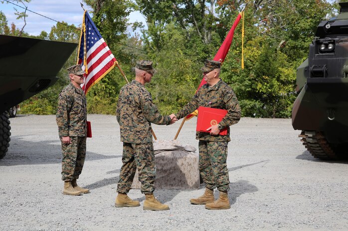 Marine Corps Systems Command Sgt. Maj. Allen Goodyear, left, looks on as Gen. Eric M. Smith, middle, assistant commandant of the Marine Corps, congratulates Col. Kirk D. Mullins (right) on his retirement from the Marine Corps after 31 years of faithful service. The ceremony was held at Marine Corps Base Quantico’s 395-acre Transportation Demonstration Support Area on Sept. 29, 2022. Mullins was instrumental to the development, acquisition and fielding of the ACV, designed and built to replace the Corps’ legacy AAVs, which have been in service since 1972.