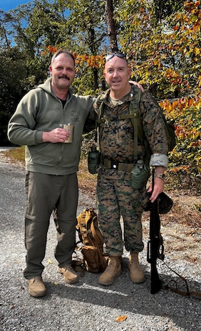 Retired Marine Corps Col. Randy Hoffman, left, accompanied recently retired Col. Kirk Mullins during his last 20-mile ruck march in the Marine Corps. Hoffman marched 19-miles alongside Mullins, who reserved the last mile for his grandson. Hoffman and Mullins stopped to toast and remember two of their fellow Marines, 2nd Lt Shawn Coll and Lieutenant Col. Bret Hart, who have passed away.