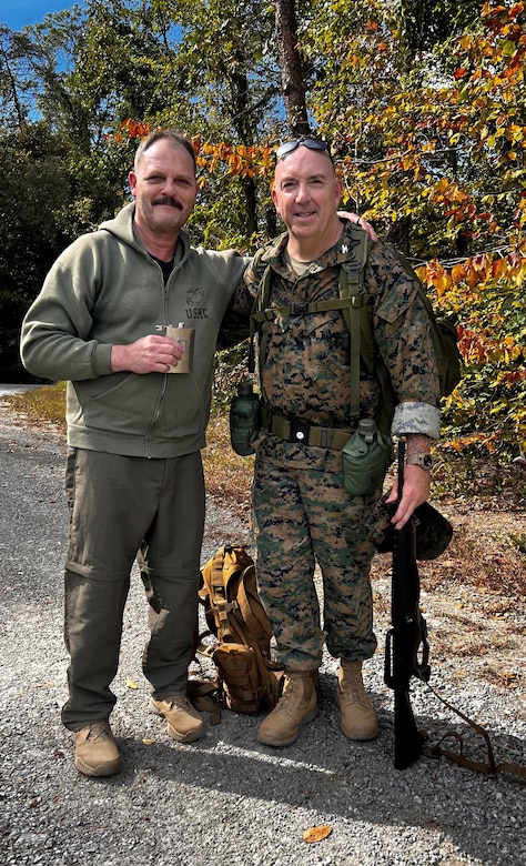 Retired Marine Corps Col. Randy Hoffman, left, accompanied recently retired Col. Kirk Mullins during his last 20-mile ruck march in the Marine Corps. Hoffman marched 19-miles alongside Mullins, who reserved the last mile for his grandson. Hoffman and Mullins stopped to toast and remember two of their fellow Marines, 2nd Lt Shawn Coll and Lieutenant Col. Bret Hart, who have passed away.