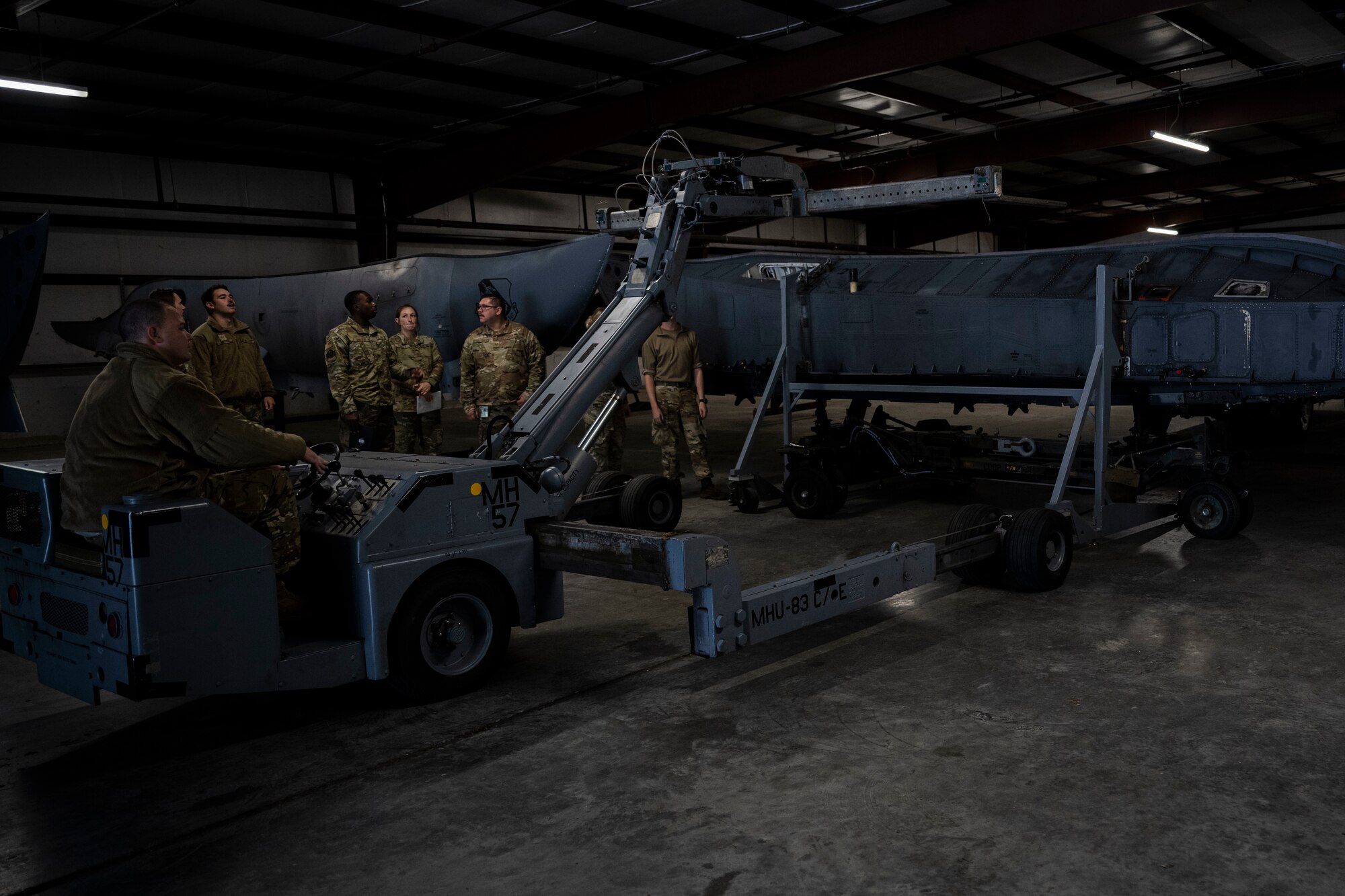 Airmen assigned to the 4th Maintenance Group mount a conformal fuel tank to a CFT stand at Seymour Johnson Air Force Base, North Carolina, Oct. 3, 2022. The stands are used to hold a conformal, or extra, fuel tank of an F-15E Strike Eagle.