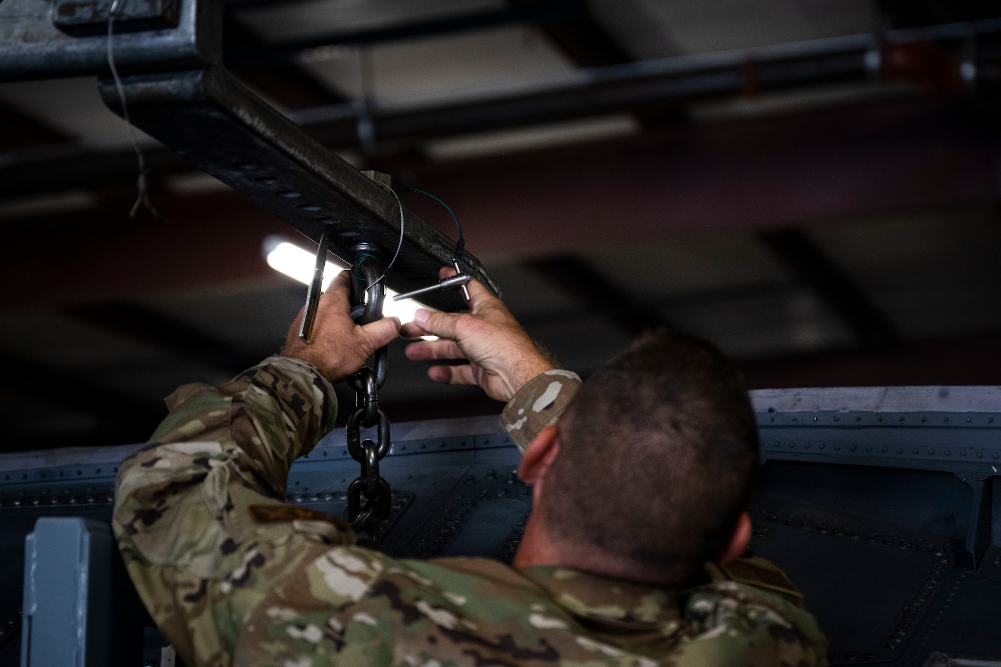 An Airman assigned to the 4th Maintenance Group puts a pin in a conformal fuel tank stand at Seymour Johnson Air Force Base, North Carolina, Oct. 3, 2022. The new stands will allow units to have a larger number of stands on hand.