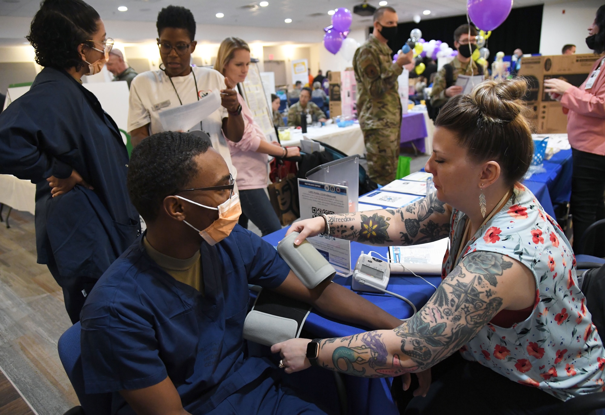Jennifer Guy, 81st Training Wing health promotion specialist, provides a wellness screening on U.S. Air Force Airman 1st Class Gabriel Dudley, 81st Dental Squadron dental technician, during the 11th Annual 81st Medical Group Health Expo inside the Keesler Medical Center auditorium at Keesler Air Force Base, Mississippi, October 7, 2022. The 81st MDG hosted the walk-in event, which included information booths and scheduling appointments for multiple types of cancer and chronic diseases in honor of Breast Cancer Awareness Month. (U.S. Air Force photo by Kemberly Groue)
