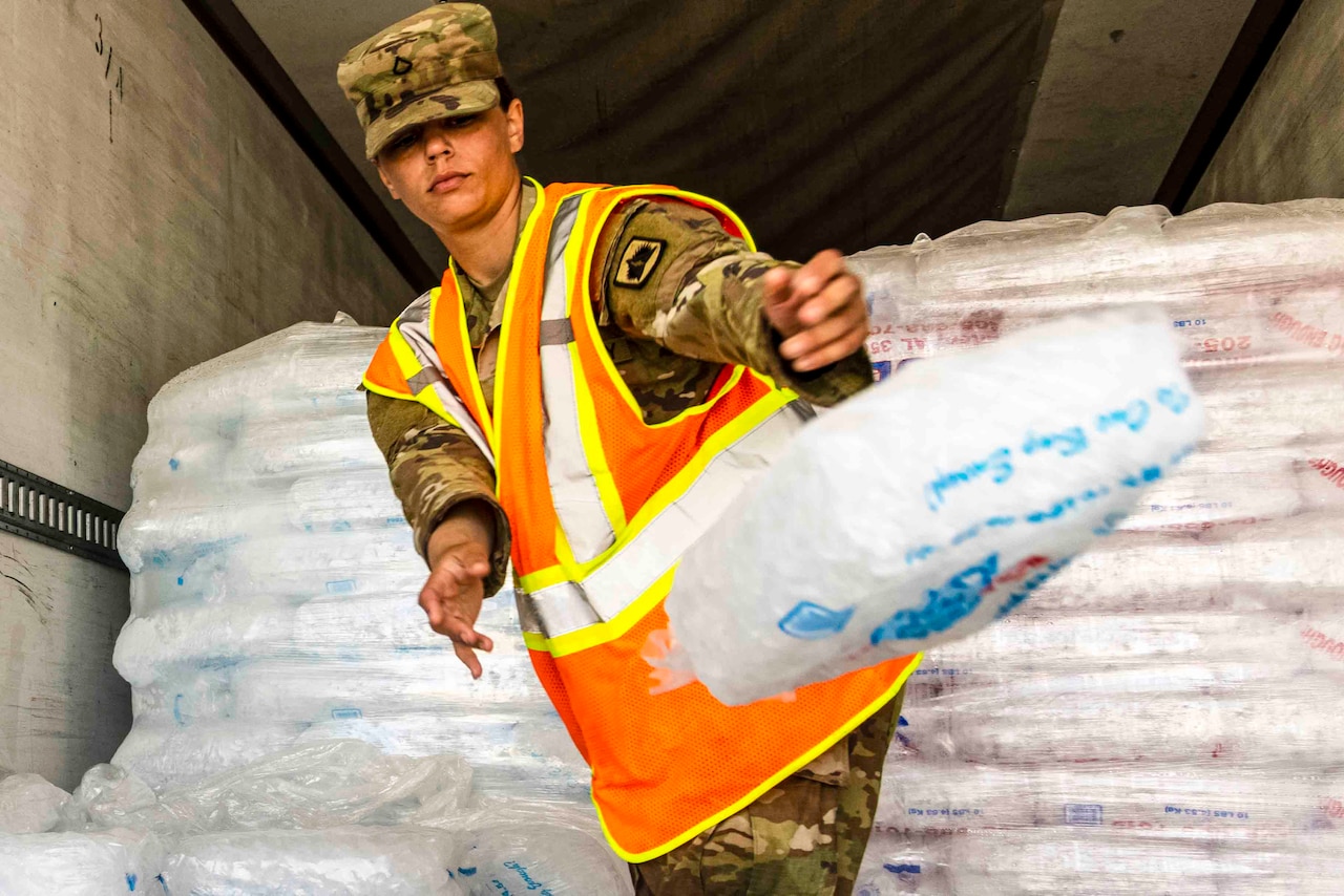 A guardsman throws a bag of ice.