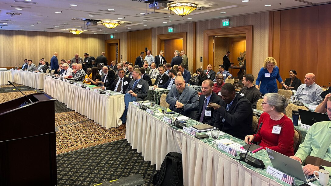 a large group of people sitting in a conference room