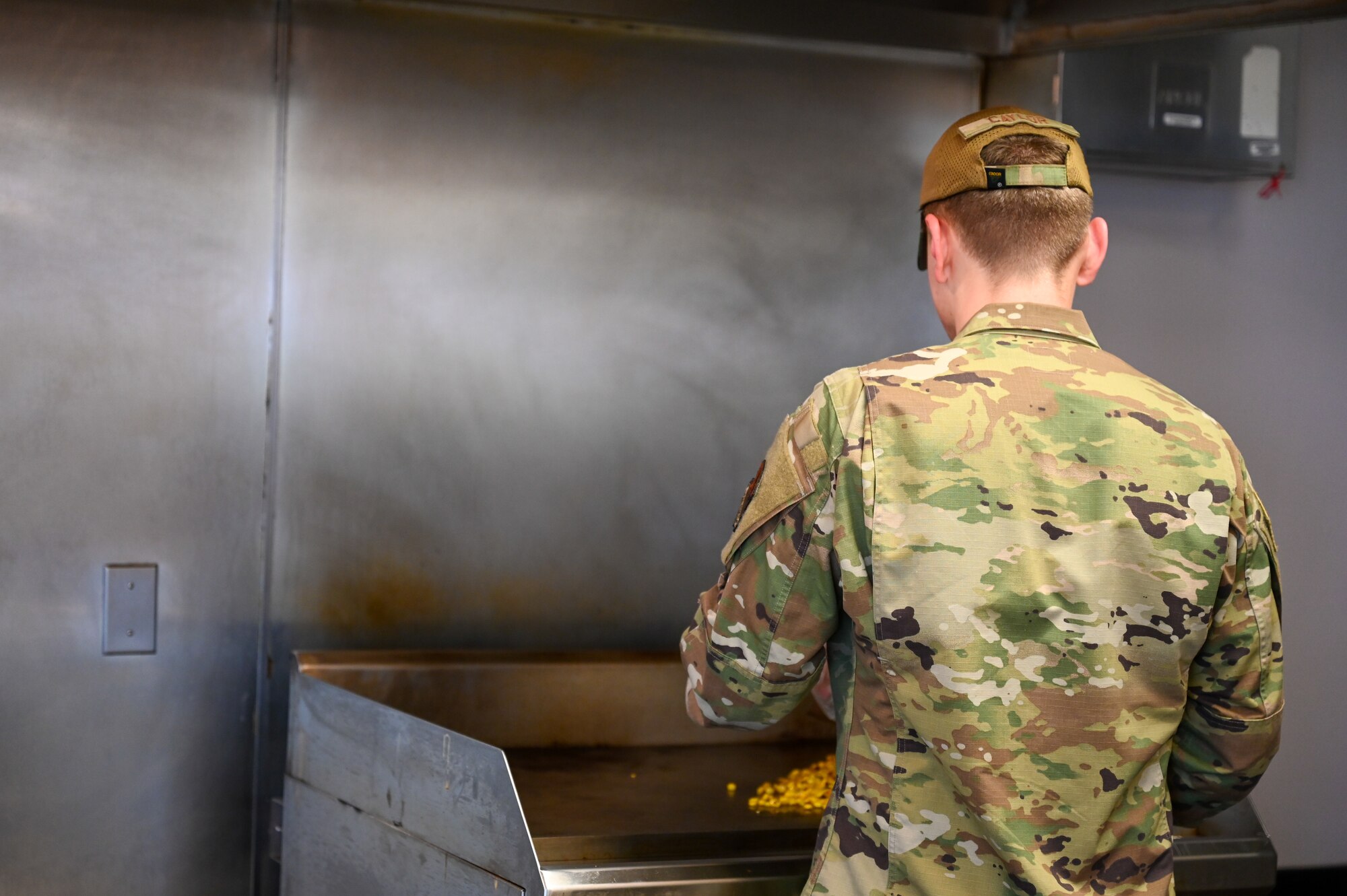 A photo of an Airman cooking.