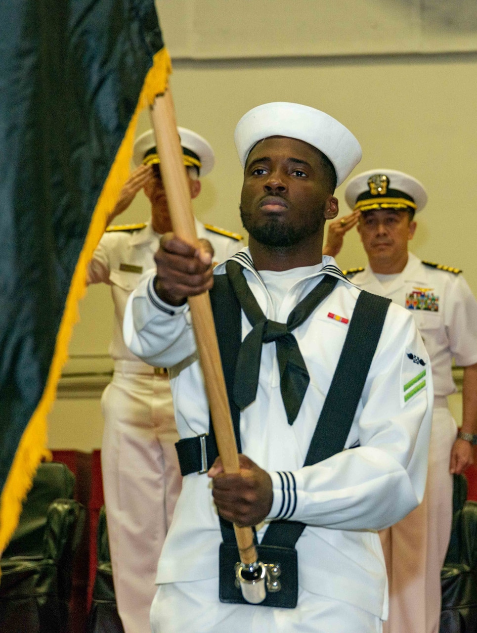Sailors parade the colors during a change of command ceremony aboard the U.S. Navy’s only forward-deployed aircraft carrier, USS Ronald Reagan (CVN 76), in the Sea of Japan, Oct. 7. During the ceremony, Goldhammer was properly relieved by Capt. Daryle Cardone as the commanding officer. Ronald Reagan, the flagship of Carrier Strike Group 5, provides a combat-ready force that protects and defends the United States, and supports alliances, partnerships and collective maritime interests in the Indo-Pacific region. (U.S. Navy photo by Mass Communication Specialist 3rd Class Gray Gibson)