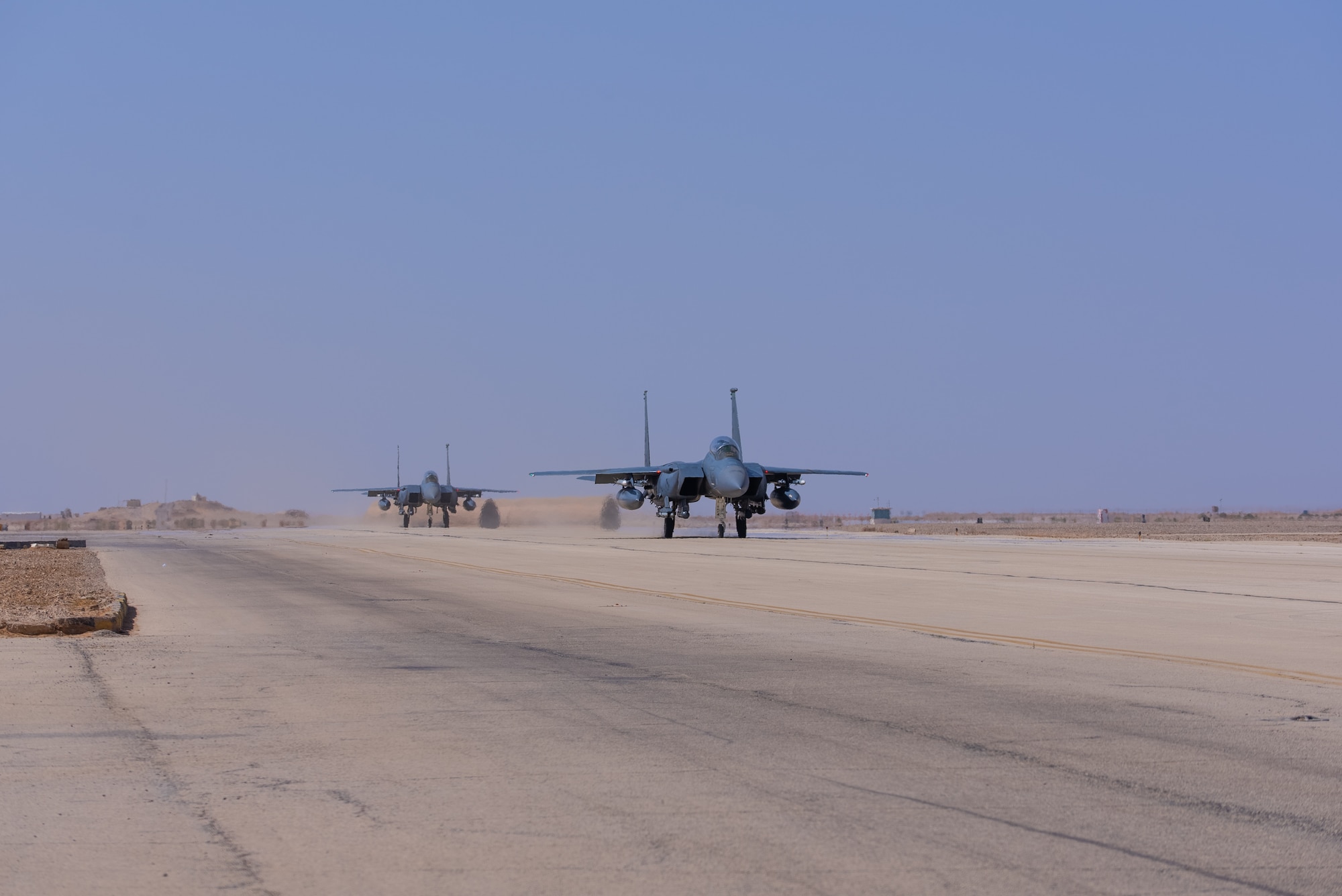 U.S. Air Force F-15E Strike Eagles with the 335th Expeditionary Fighter Squadron taxi on a runaway at at an undisclosed location in Southwest Asia, September 27-28, 2022. The F-15E tested its capability to rapidly mobilize at a Forward Operating Site. (U.S Air Force Photo by Tech Sgt. Melissa Isidro)