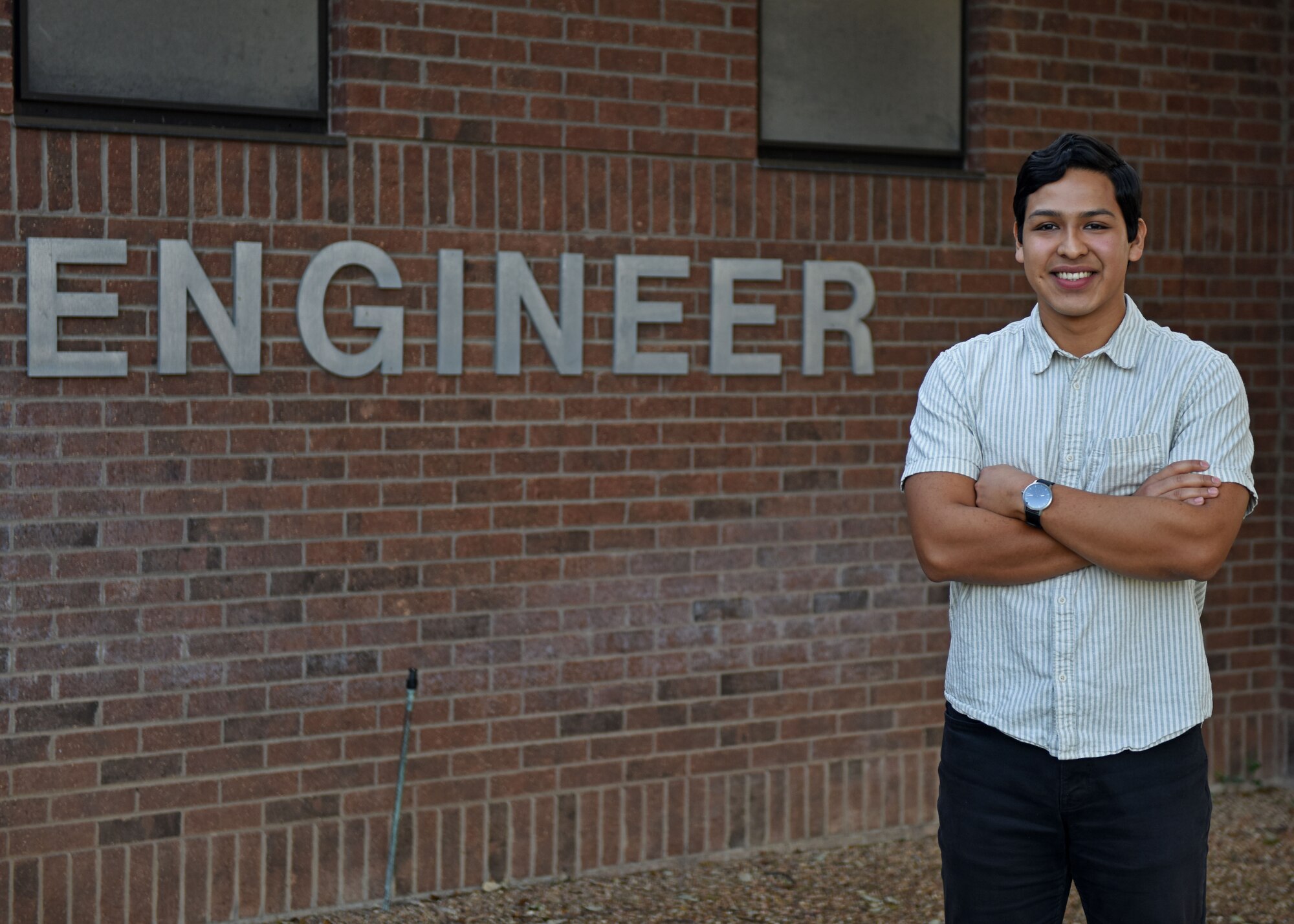 Rafael Mendoza, 17th Civil Engineer Squadron mechanical engineer, stands in front of the 17th CES building, Goodfellow Air Force Base, Texas, Oct. 4, 2022. The partnership between Goodfellow and Angelo State University provided Mendoza an opportunity to become an intern with the 17th CES in 2019. (U.S. Air Force photo by Airman 1st Class Sarah Williams)