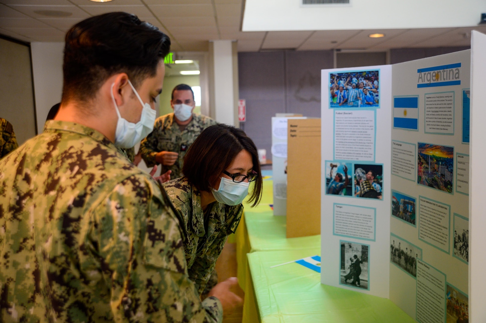 SAN DIEGO (Oct. 5, 2022) Cmdr. Nelly Rice, Navy Medicine Readiness and Training Command San Diego’s acting executive officer (center), views a poster showcasing Argentinian culture with Hospitalman Luis Trejo (left), during a Hispanic Heritage Month event hosted by NMRTC San Diego’s Diversity Committee Team at the hospital, Oct. 5 2022. NMRTC San Diego's mission is to prepare service members to deploy in support of operational forces, deliver high quality healthcare services and shape the future of military medicine through education, training and research. NMRTC San Diego employs more than 6,000 active duty military personnel, civilians and contractors in Southern California to provide patients with world-class care anytime, anywhere. (U.S. Navy photo by Mass Communication Specialist 3rd Class Raphael McCorey)