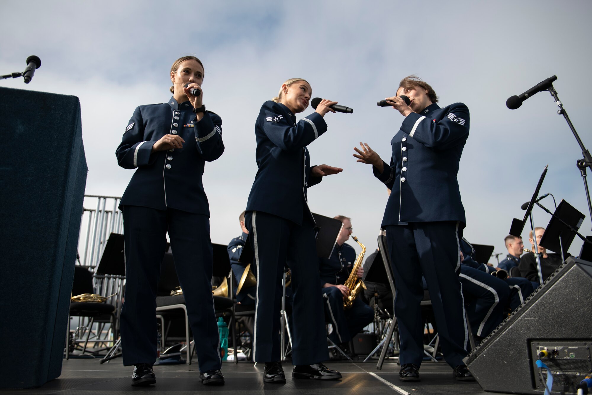 From left to right, U.S. Air Force Senior Airman Anna Gilpatrick, Airman 1st Class Natalie Angst, and Staff Sgt. Alena Zidlicky, USAF Band of the Golden West vocalists, perform at the Presidio Tunnel Tops, San Francisco, California, Oct. 6, 2022.