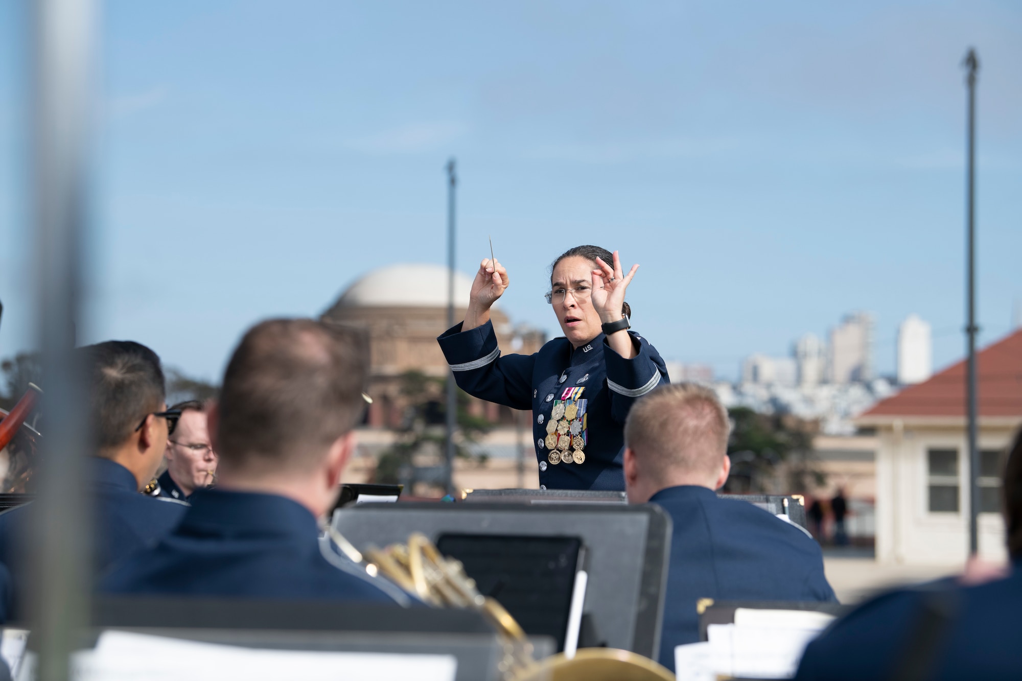 U.S. Air Force Lt. Col. Cristina Urrutia, USAF Band of the Golden West commander and conductor, conducts a performance at the Presidio Tunnel Tops, San Francisco, California, Oct. 6, 2022.