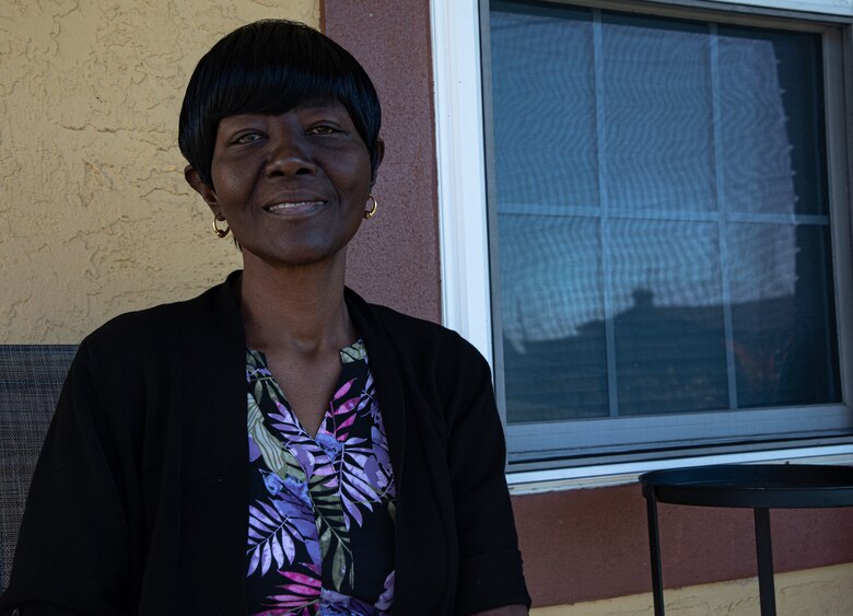 Woman sits on porch in chair