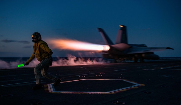 WATERS BETWEEN JAPAN AND THE REPUBLIC OF KOREA (Oct. 5, 2022) Lt. William Peters, from Webster, Massachusetts, signals for the launch of an F/A-18E Super Hornet, attached to the Dambusters of Strike Fighter Squadron (VFA) 195, from the flight deck of the U.S. Navy’s only forward-deployed aircraft carrier, USS Ronald Reagan (CVN 76), in the Sea of Japan, Oct. 5. Ronald Reagan, the flagship of Carrier Strike Group 5, provides a combat-ready force that protects and defends the United States, and supports alliances, partnerships and collective maritime interests in the Indo-Pacific region. (U.S. Navy photo by Mass Communication Specialist 2nd Class Michael B. Jarmiolowski)