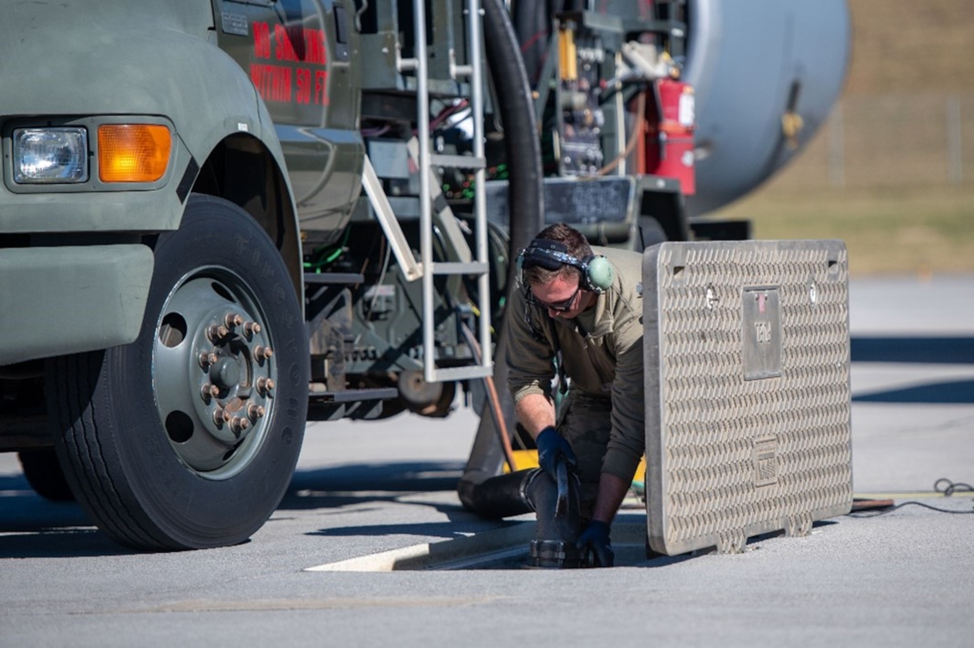 U.S. Air Force Airman from McGhee Tyson Air National Guard Base secures fuels lines and additional wires during a hot-pit refueling of a KC-135 Stratotanker assigned to the 92nd Air Refueling Wing at McGhee Tyson Air National Guard Base, TN, Oct. 6, 2022. Two KC-135 Stratotankers simultaneously conducted 72-hour single-aircraft endurance missions, demonstrating multi-day tanker mission generation capabilities. (U.S. Air Force photo by Airman 1st Class Jenna A. Bond)