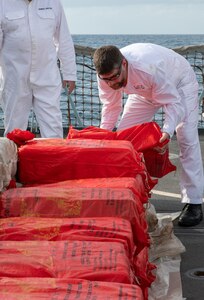 GULF OF OMAN (Oct. 2, 2022) Personnel from the United Kingdom’s Royal Navy frigate HMS Montrose (F236) inventory illicit drugs seized from a fishing vessel in international waters in the Gulf of Oman, Oct. 2.