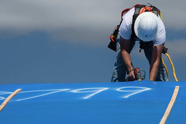 Saturday, Oct 8, 2022, the first Blue Roof install in Ft Myers, Florida. Roofer Jonathan Whitaker removes D Ring. 
Operation Blue Roof is designed to protect property, reduces temporary housing costs, and allows residents to remain in their homes while recovering from the storm.
A resident begins by submitting a Right of Entry (ROE) request through the blueroof.us website or calling 888-ROOF-BLU (888-766-3258). (USACE photo by Bri Sanchez)