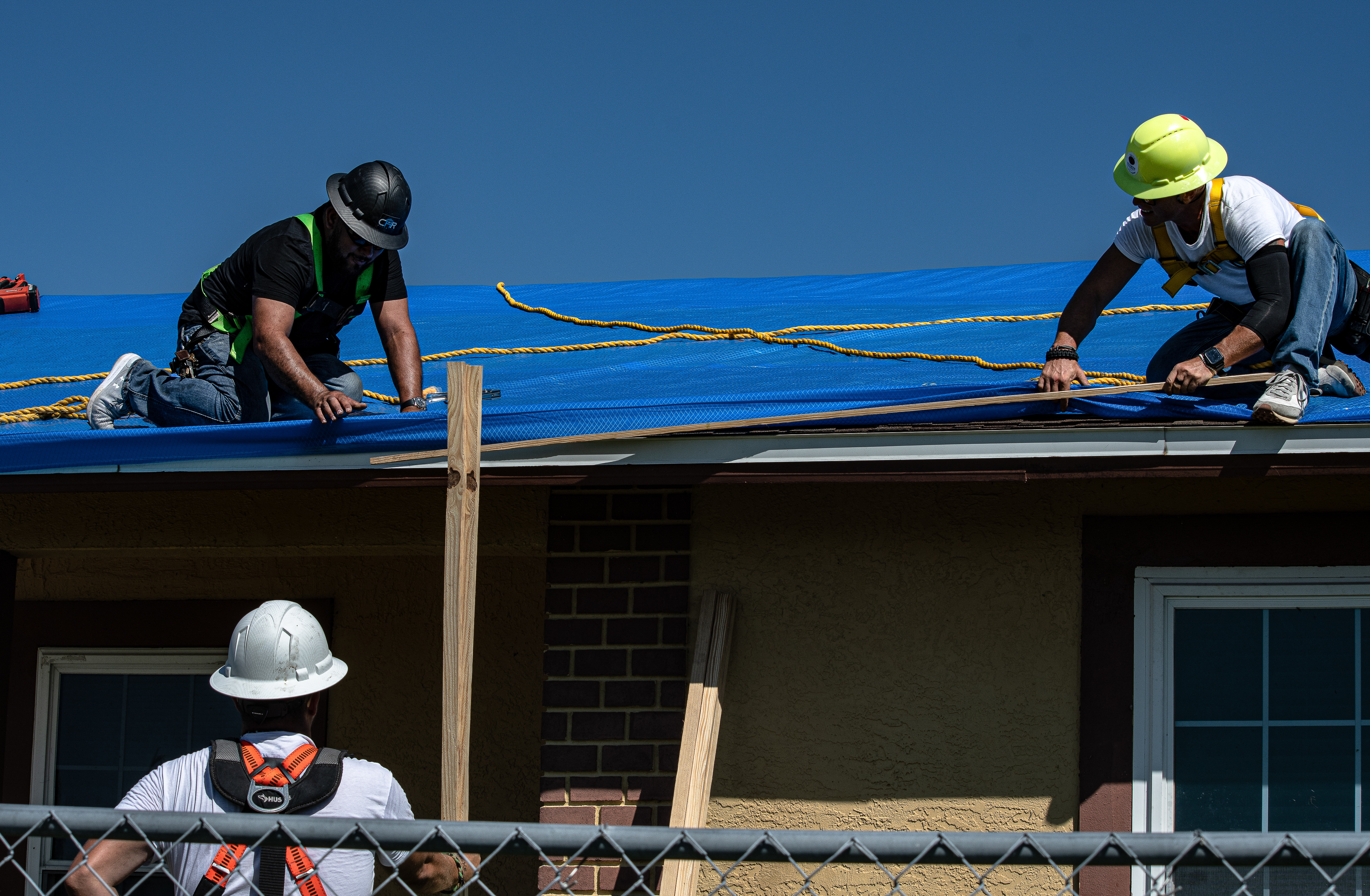 Saturday, Oct 8, 2022, the first Blue Roof install in Ft Myers, Florida. Roofer Jonathan Whitaker removes D Ring. 
Operation Blue Roof is designed to protect property, reduces temporary housing costs, and allows residents to remain in their homes while recovering from the storm.
A resident begins by submitting a Right of Entry (ROE) request through the blueroof.us website or calling 888-ROOF-BLU (888-766-3258). (USACE photo by Bri Sanchez)