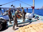 221010-G-NO146-1001 GULF OF OMAN (Oct. 10, 2022) Personnel from U.S. Coast Guard fast response cutter USCGC Glen Harris (WPC 1144) inventory illicit drugs seized from a fishing vessel in international waters in the Gulf of Oman, Oct. 10.