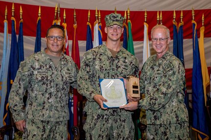 Rear Adm. Joseph DiGuardo Jr. and Adm. Darly Caudle, Commander, U.S. Fleet Forces Command, present Lt. Patrick Gest (center) with the Rear Admiral Draper L. Kauffman Leadership Award, Sept. 30. DiGuardo also retired from the U.S. Navy following the event.