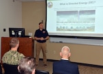 JOINT BASE SAN ANTONIO-FORT SAM HOUSTON – (Sept. 30, 2022) – Peter Sprenger assigned to the Directed Energy Bioeffects Department of Naval Medical Research Unit (NAMRU) San Antonio, speaks about directed energy (DE) during the second “Mission Possible,” an information-sharing event held at the Tri-Service Research Laboratory. The purpose of “Mission Possible” is to better inform members of the command on the tactics, techniques, and procedures of the three science directorates to include the resource acquisitions and administrative directorates. NAMRU San Antonio’s mission is to conduct gap driven combat casualty care, craniofacial, and directed energy research to improve survival, operational readiness, and safety of Department of Defense personnel engaged in routine and expeditionary operations. It is one of the leading research and development laboratories for the U.S. Navy under the DoD and is one of eight subordinate research commands in the global network of laboratories operating under the Naval Medical Research Center in Silver Spring, Md. (U.S. Navy photo by Burrell Parmer, NAMRU San Antonio Public Affairs/released)