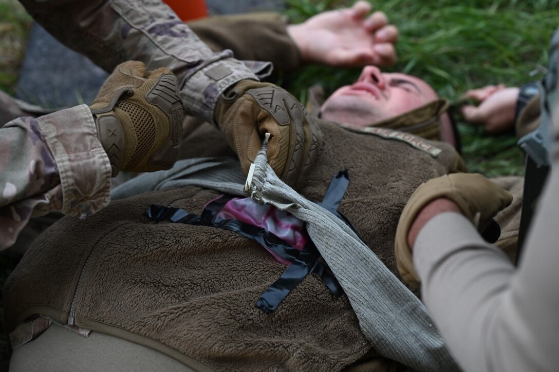 U.S. Air Force Airmen assigned to the 28th Civil Engineer Squadron bandage a wound during the Prime Base Engineer Emergency Force, also referred to as BEEF, Challenge at Ellsworth Air Force Base, S.D. Sept. 22, 2022.