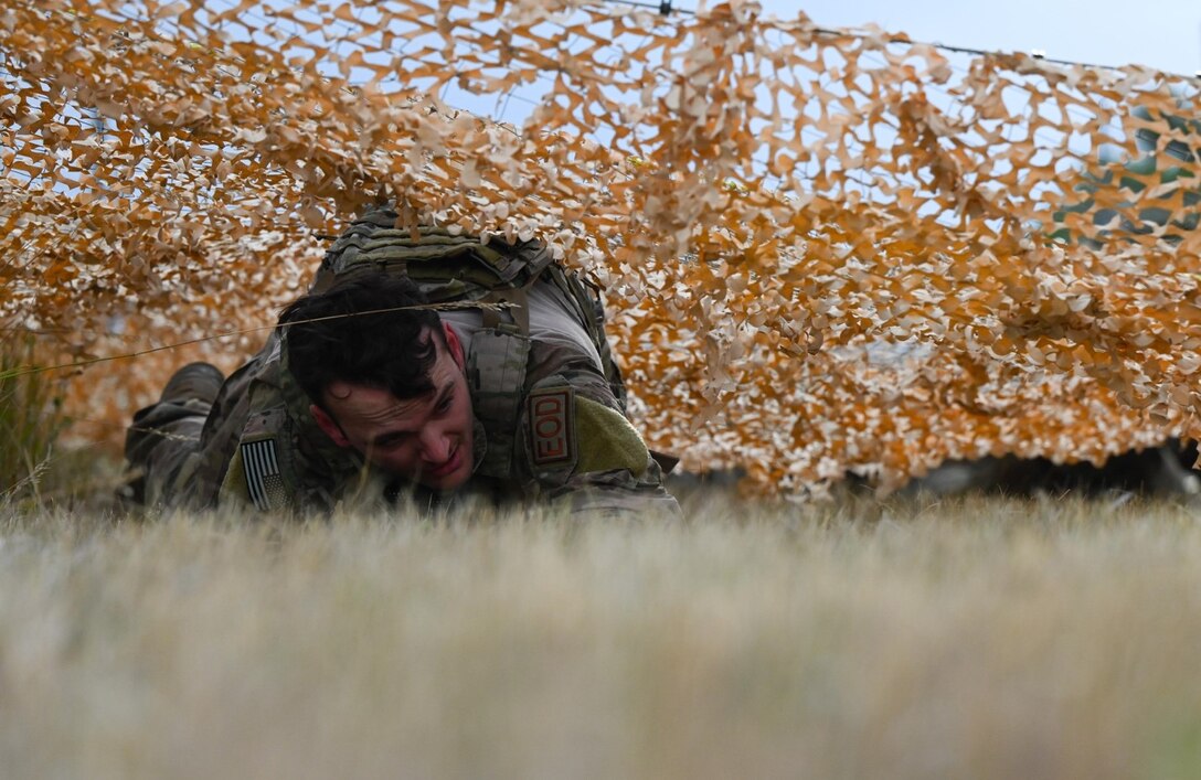U.S. Air Force Staff Sgt. Dillon Willis, 28th Civil Engineer Squadron explosive ordnance disposal technician, performs a low crawl during the Prime Base Engineer Emergency Force, also referred to as BEEF, Challenge at Ellsworth Air Force Base, S.D. Sept. 22, 2022.