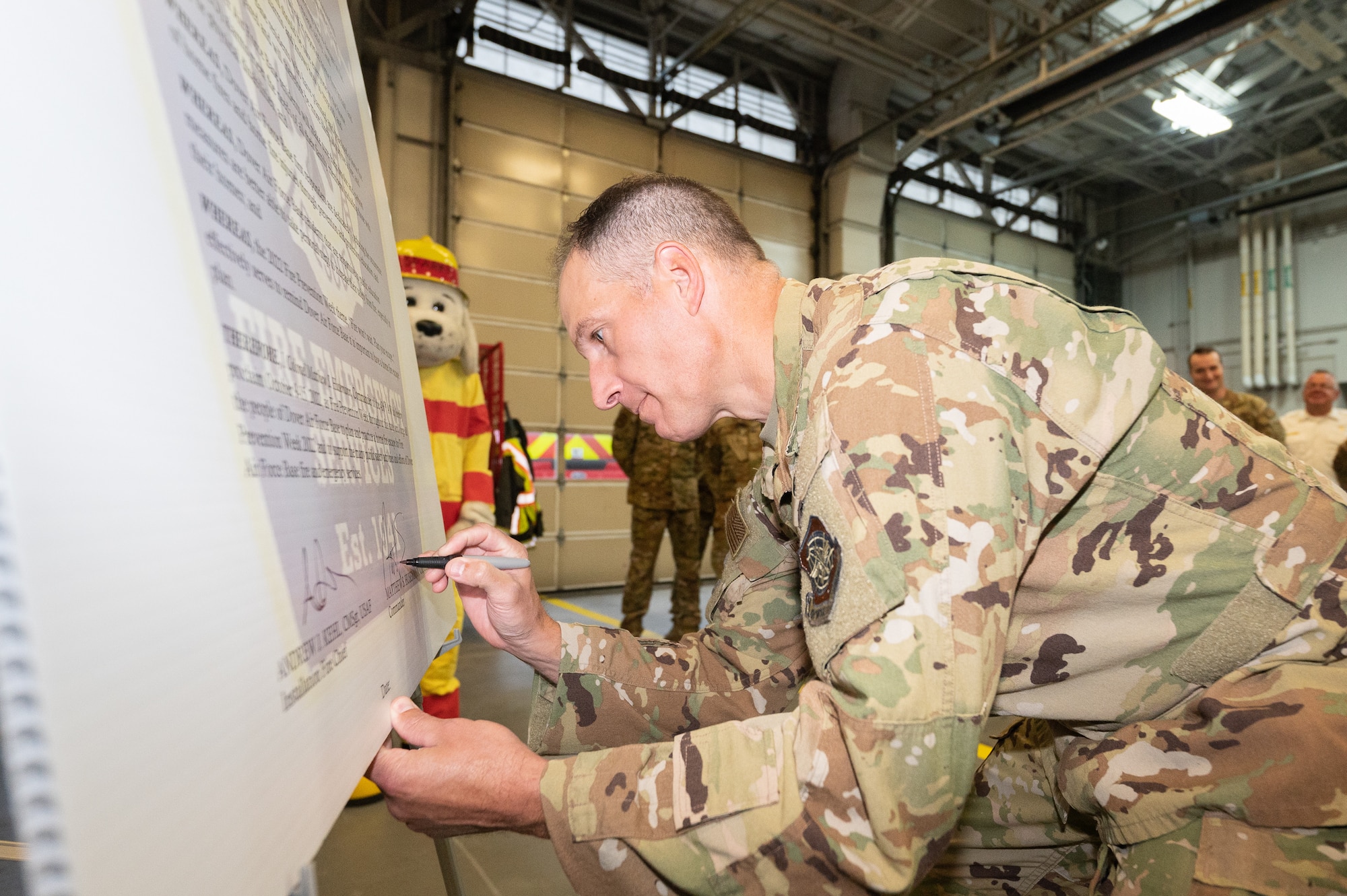 Col. Matt Husemann, 436th Airlift Wing commander, signs the 2022 Fire Prevention Week proclamation, Oct. 4, 2022, at Dover Air Force Base, Delaware. During Fire Prevention Week, the Dover AFB Fire Department hosts various activities to raise fire safety awareness for Airmen and their families. (U.S. Air Force photo by Mauricio Campino)