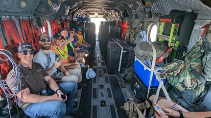 Civilian search and rescue personnel on a CH-47F Chinook helicopter operated by New York Army National Guard Soldiers assigned to B Company, 3rd Battalion, 126th Aviation Regiment, head to a mission on Sanibel Island, Florida, Oct. 2, 2022. At the direction of Gov. Kathy Hochul, the New York National Guard deployed two Chinook helicopters and 11 Soldiers to help the Florida National Guard respond to the destruction caused by Hurricane Ian.