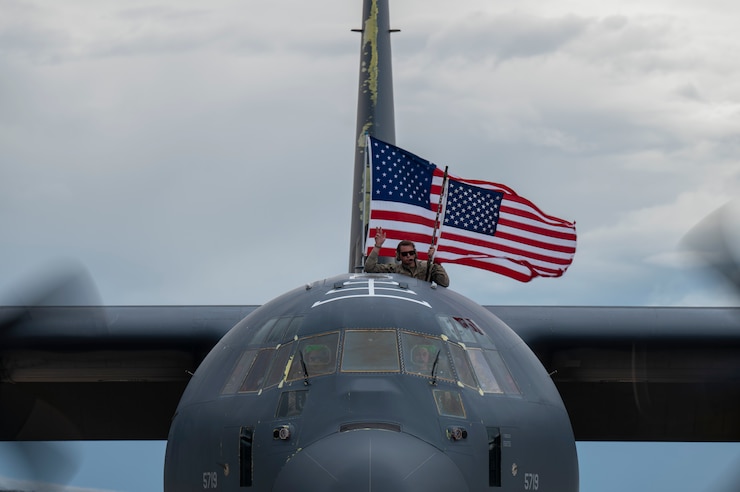 A photo of an Airman waving a flag