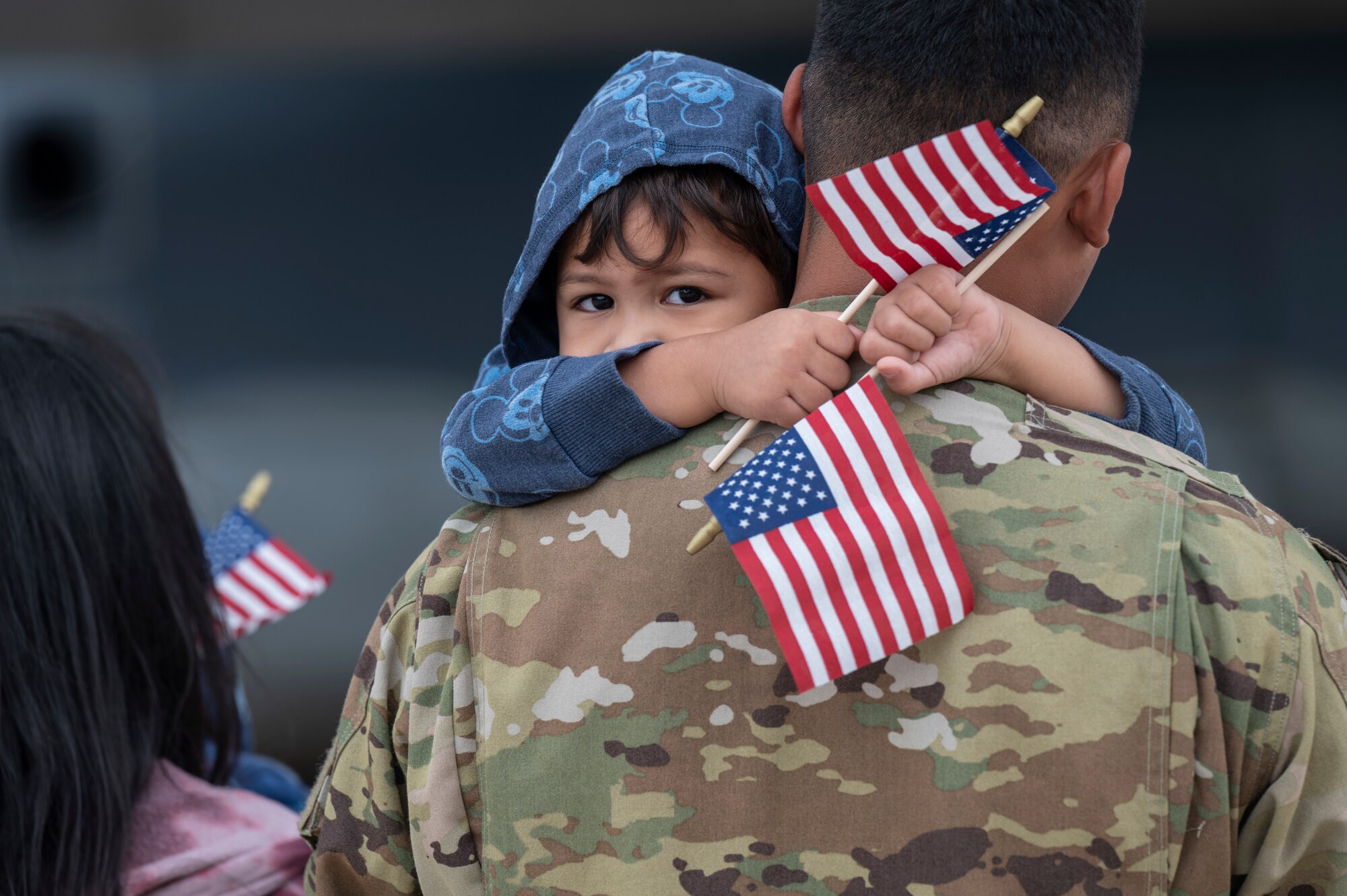 A photo of Airmen hugging their family
